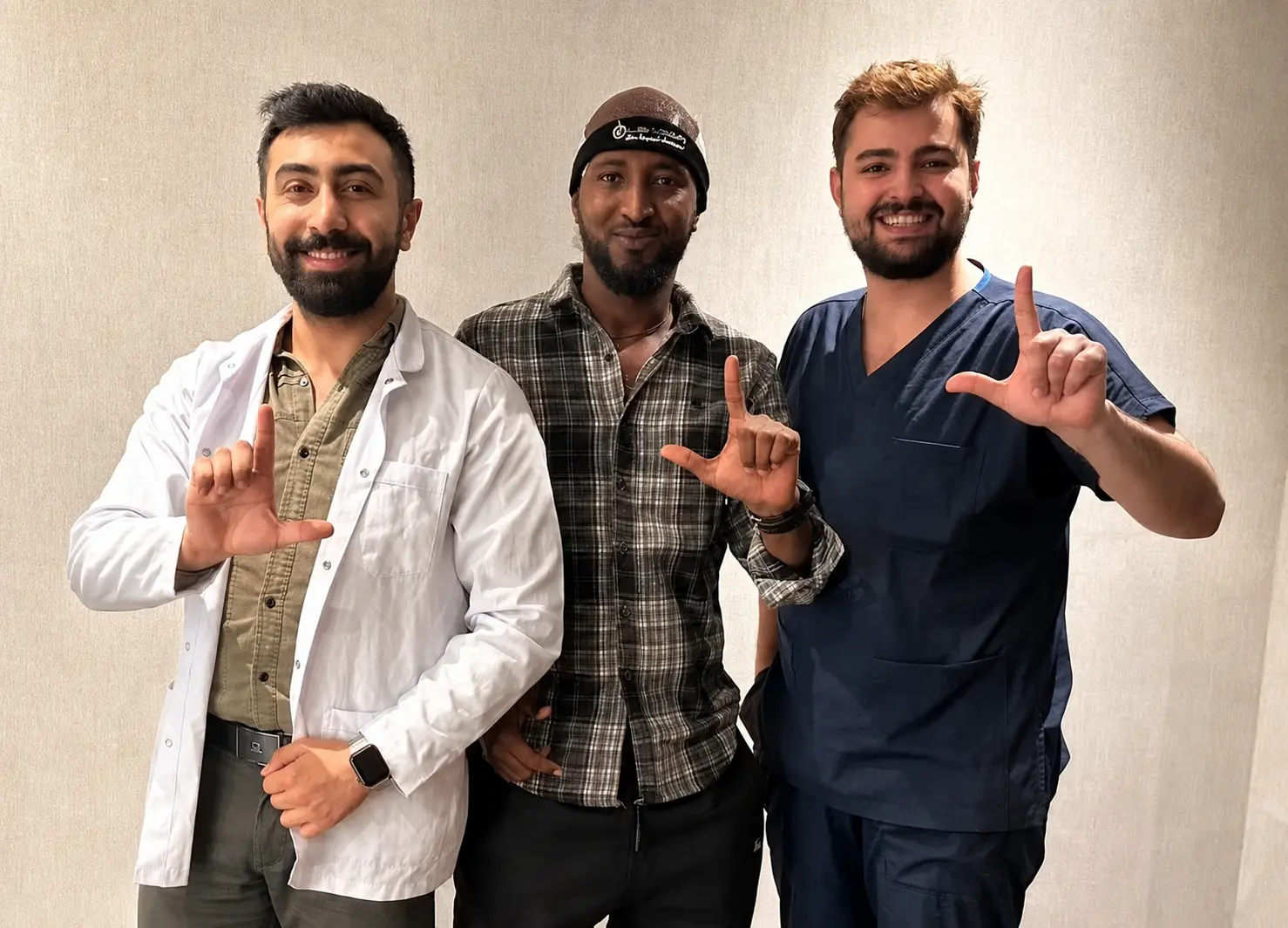 Hair transplant specialists supporting a patient after treatment